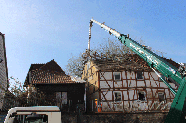Das Haus mit der Nummer 26 an der Straße Westendorf wird abgerissen. Zwei Baufirmen kümmern sich aktuell darum, das Gebäude abzutragen.